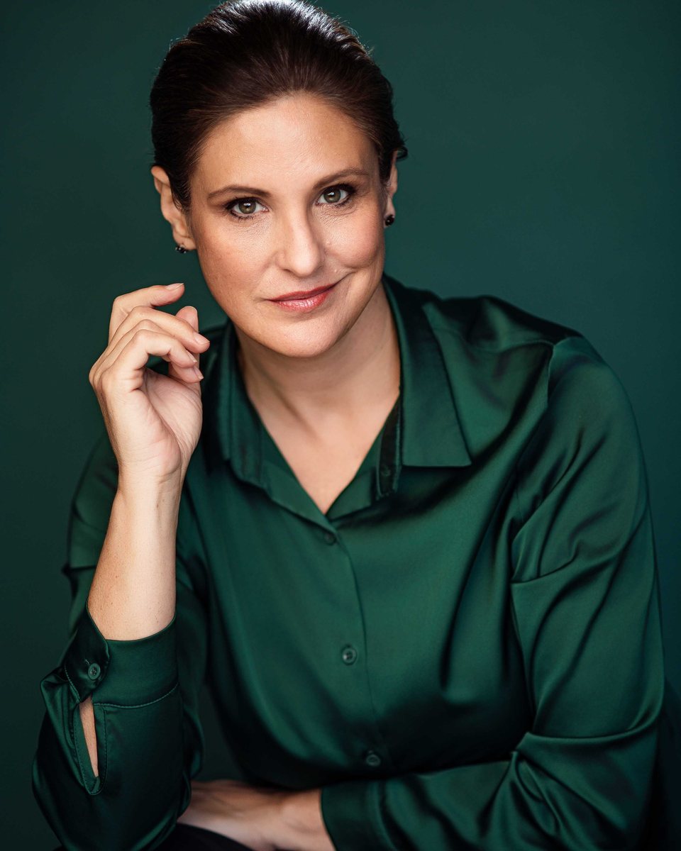 Angie Holmes in a green satin blouse
